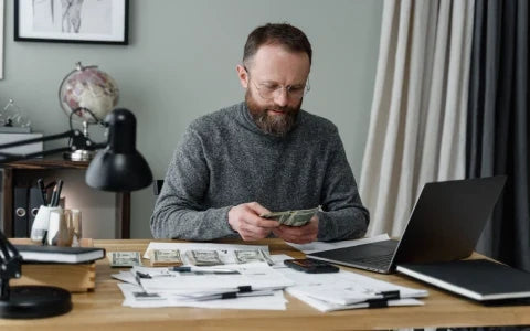 Business employee reviewing a large cash transaction while preparing to e-file Form 8300 through an electronic reporting system.